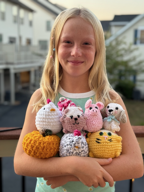 Victoria holding her beautiful crochet creations